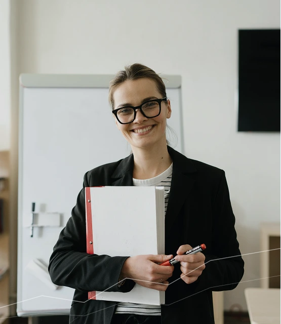 Professional business consultant holding documents and marker in an office