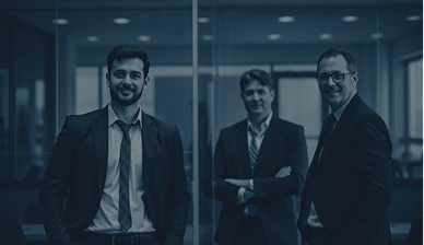 Three business professionals standing in modern office